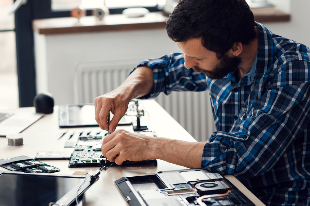 Man Repairing A Computer