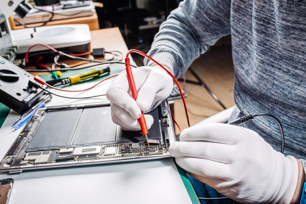 A Technician Repairing A Tablet